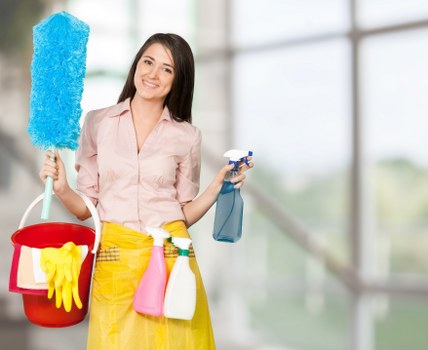 A cleaned carpet area with a vacuum and cleaning tools nearby